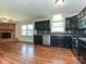 Updated kitchen with black cabinets, stainless steel appliances, a decorative backsplash, and wood flooring at 12300 Eva St, Matthews, NC 28105