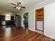 Open floor plan with wood floors, ceiling fan, stainless appliances, and access to a laundry closet with a washer at 12300 Eva St, Matthews, NC 28105