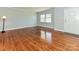Inviting living room with original hardwood floors, large windows, and neutral paint offering a bright atmosphere at 12300 Eva St, Matthews, NC 28105