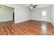 Bright living room with wood flooring, neutral walls, a door, and an entrance to another room at 12300 Eva St, Matthews, NC 28105