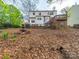 Spacious backyard features a wooden deck, mature trees, and a classic fountain at 12708 Hollyhock Ln, Huntersville, NC 28078