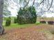 Backyard featuring lush greenery, mature trees, and a peaceful, park-like setting at 12708 Hollyhock Ln, Huntersville, NC 28078