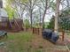 Spacious backyard with a wooden deck, mature trees, and a charming wooden fence at 12708 Hollyhock Ln, Huntersville, NC 28078