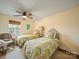 Bright bedroom featuring twin beds, window, ceiling fan, and comfortable seating at 12708 Hollyhock Ln, Huntersville, NC 28078