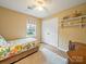 Well-lit bedroom with wood floors, closet space, and a view of the backyard at 12708 Hollyhock Ln, Huntersville, NC 28078