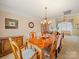 Formal dining room featuring a chandelier, wood table, and seating for eight with access to the living area at 12708 Hollyhock Ln, Huntersville, NC 28078