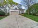 Charming two-story home with a beige garage door and a welcoming front porch at 12708 Hollyhock Ln, Huntersville, NC 28078