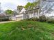 Traditional home with a beige garage door and a welcoming front porch, set on a lush lawn at 12708 Hollyhock Ln, Huntersville, NC 28078