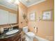 Nicely decorated half bathroom with a black granite vanity and neutral decor at 12708 Hollyhock Ln, Huntersville, NC 28078