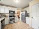 Well-equipped kitchen with stainless steel appliances, granite countertops, and a view to the dining area at 12708 Hollyhock Ln, Huntersville, NC 28078