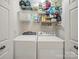 Convenient laundry room with washer, dryer, and ample shelving for storage at 12708 Hollyhock Ln, Huntersville, NC 28078