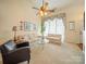 Inviting living room featuring comfortable seating, a vaulted ceiling, and beautiful natural light at 12708 Hollyhock Ln, Huntersville, NC 28078