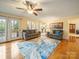 Bright living room with hardwood floors, natural light, and seamless access to the kitchen and outdoor deck at 12708 Hollyhock Ln, Huntersville, NC 28078