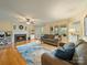 Spacious living room with a fireplace, ceiling fan, and hardwood floors, perfect for relaxing and entertaining guests at 12708 Hollyhock Ln, Huntersville, NC 28078