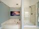 Relaxing bathroom with a corner tub and a separate glass-enclosed shower at 12708 Hollyhock Ln, Huntersville, NC 28078
