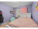 Bright bedroom features a white bed frame and light purple walls at 12804 Lismorre Castle Ct, Charlotte, NC 28273
