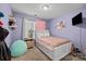Bedroom featuring pink and purple decorations, including plushies, pillows, and bedding at 12804 Lismorre Castle Ct, Charlotte, NC 28273