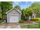 Exterior view of a charming home with a well-manicured lawn, landscaping, and an attached garage at 12804 Lismorre Castle Ct, Charlotte, NC 28273