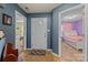 Inviting hallway with views into two additional bedrooms, tile floors, and blue paint at 12804 Lismorre Castle Ct, Charlotte, NC 28273