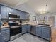 Modern kitchen featuring stainless steel appliances, grey cabinets, and a stylish backsplash at 12804 Lismorre Castle Ct, Charlotte, NC 28273