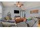 Bright and airy living room with a large sectional sofa, hardwood floors, and a ceiling fan at 12804 Lismorre Castle Ct, Charlotte, NC 28273