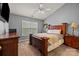 Comfortable main bedroom with carpet, a wooden bed frame, and ample natural light at 12804 Lismorre Castle Ct, Charlotte, NC 28273