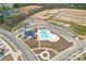 Aerial view of the community pool, clubhouse, tennis courts, and surrounding development at 1409 Augustus Beamon Dr, Indian Trail, NC 28079