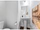 Bathroom with pedestal sink, toilet, and a towel hanger at 1409 Augustus Beamon Dr, Indian Trail, NC 28079