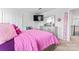 Bright bedroom featuring a playful pink and purple color scheme, a dresser, and a tv at 1409 Augustus Beamon Dr, Indian Trail, NC 28079