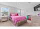 Vibrant bedroom with bright pink bedding, neutral walls, and a window providing natural light at 1409 Augustus Beamon Dr, Indian Trail, NC 28079