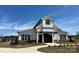 Striking clubhouse featuring a modern farmhouse design with white siding and black trim at 1409 Augustus Beamon Dr, Indian Trail, NC 28079