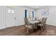 Bright dining room boasts a wooden table set for six near a door, with modern decor at 1409 Augustus Beamon Dr, Indian Trail, NC 28079