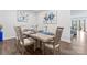 Bright dining room featuring a wooden table set for six with decorative art on the walls at 1409 Augustus Beamon Dr, Indian Trail, NC 28079