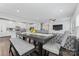 Open-concept dining area featuring a dark wood table, comfortable seating, and seamless flow to kitchen at 1409 Augustus Beamon Dr, Indian Trail, NC 28079