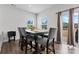 Well-lit dining area with a modern table set, large windows, and sliding glass doors to patio at 1409 Augustus Beamon Dr, Indian Trail, NC 28079