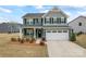 Charming two-story home with a manicured lawn and a two-car garage at 1409 Augustus Beamon Dr, Indian Trail, NC 28079