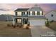 Charming two-story home with a manicured lawn and a two-car garage at 1409 Augustus Beamon Dr, Indian Trail, NC 28079