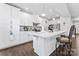 Bright kitchen with white cabinetry, a center island with seating, and modern stainless steel appliances at 1409 Augustus Beamon Dr, Indian Trail, NC 28079