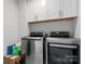 Well-equipped laundry room boasts modern LG washer and dryer and ample cabinet space at 1409 Augustus Beamon Dr, Indian Trail, NC 28079