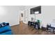 Bright living room has a blue sofa, TV, and a view into the kitchen through a doorway at 1409 Augustus Beamon Dr, Indian Trail, NC 28079
