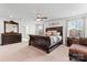 Spacious bedroom featuring elegant furniture, plush bedding, ceiling fan, and lots of natural light at 1409 Augustus Beamon Dr, Indian Trail, NC 28079