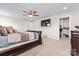 Spacious bedroom with ceiling fan, tv, en-suite bathroom, walk-in closet, and elegant furnishings at 1409 Augustus Beamon Dr, Indian Trail, NC 28079