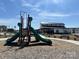 Community playground with slides and climbing structures, set against the clubhouse at 1409 Augustus Beamon Dr, Indian Trail, NC 28079