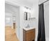 Modern bathroom features a wood vanity, stylish mirror, and shower with black curtain at 1409 Effingham Rd, Charlotte, NC 28208