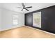 Bright bedroom features ceiling fan, two windows, and sleek, modern black and white walls at 1409 Effingham Rd, Charlotte, NC 28208