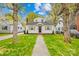 Charming home featuring a landscaped front yard, mature trees, and a inviting walkway to the front door at 1409 Effingham Rd, Charlotte, NC 28208