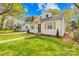 Inviting home boasting a lush lawn, and mature trees that create a warm, welcoming atmosphere at 1409 Effingham Rd, Charlotte, NC 28208
