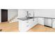 Bright kitchen features black granite countertops, modern appliances, and light hardwood floors at 1409 Effingham Rd, Charlotte, NC 28208