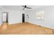 Bright living room with laminate flooring, fan, and a large window offering plenty of natural light at 1409 Effingham Rd, Charlotte, NC 28208