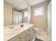 Bathroom featuring a dual sink vanity, a large mirror and a shower with glass door at 1529 S Wendover Rd, Charlotte, NC 28211